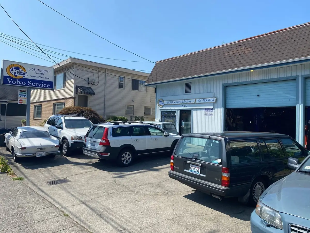 The All Vovo shop at 7535 15th Ave NW with a P1800, XC90, XC70 and 940 wagon parked out front